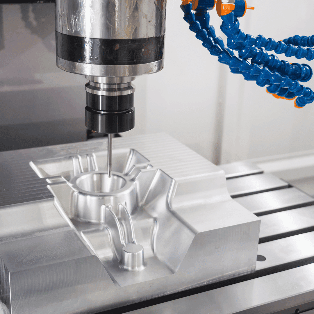 CNC equipment drilling a precision mold with coolant flow